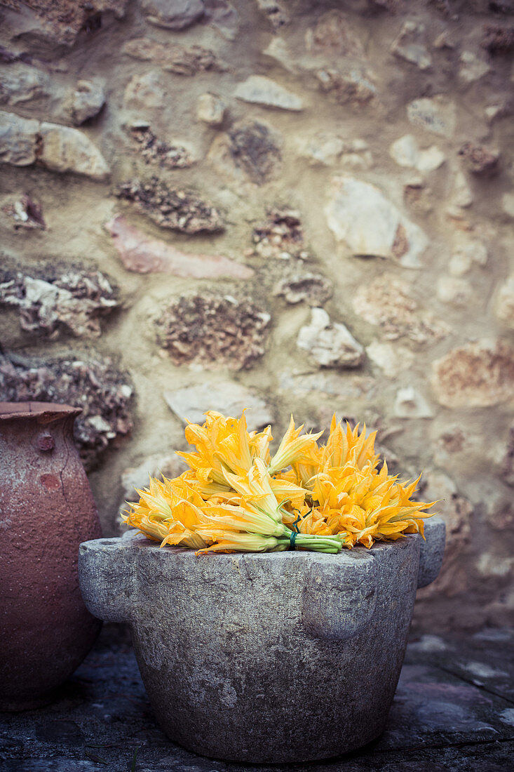 Courgette flowers in a stone pot