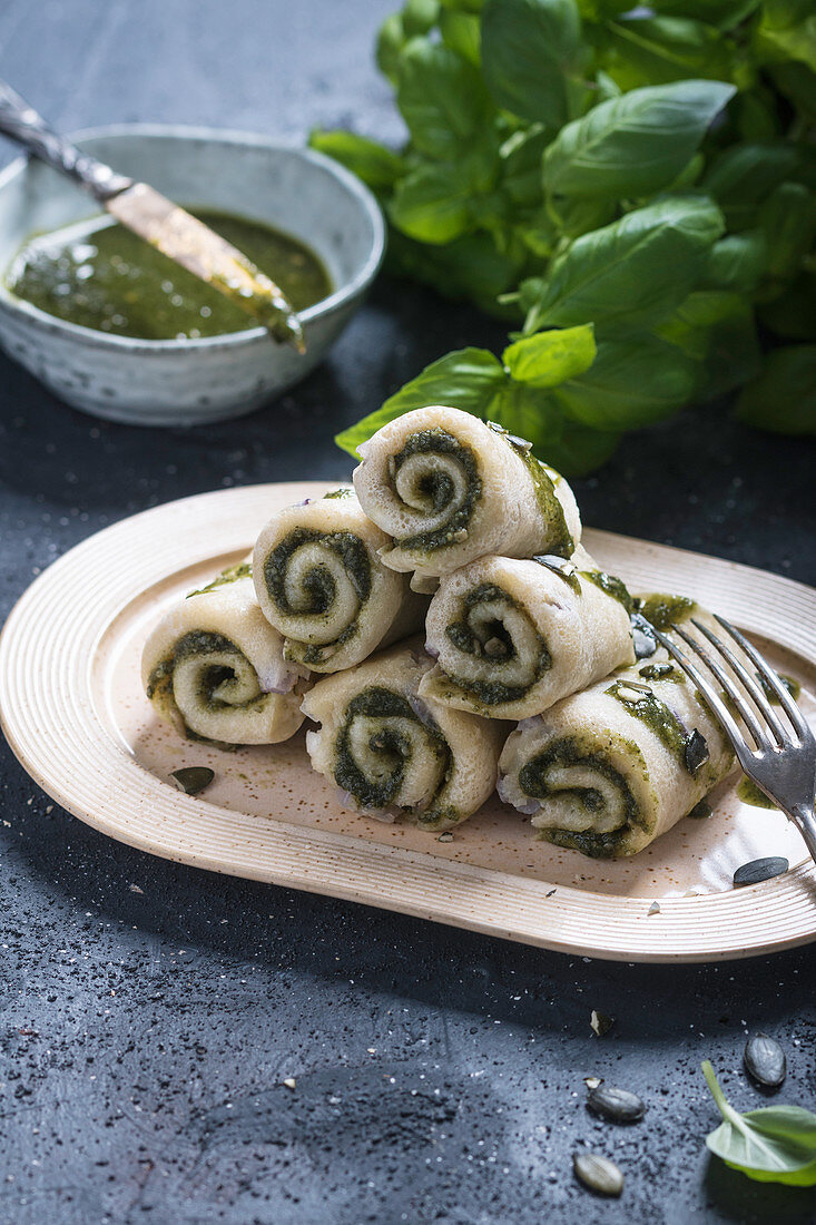 Vegan pancake rolls with red onions and pumpkin seed and basil pesto