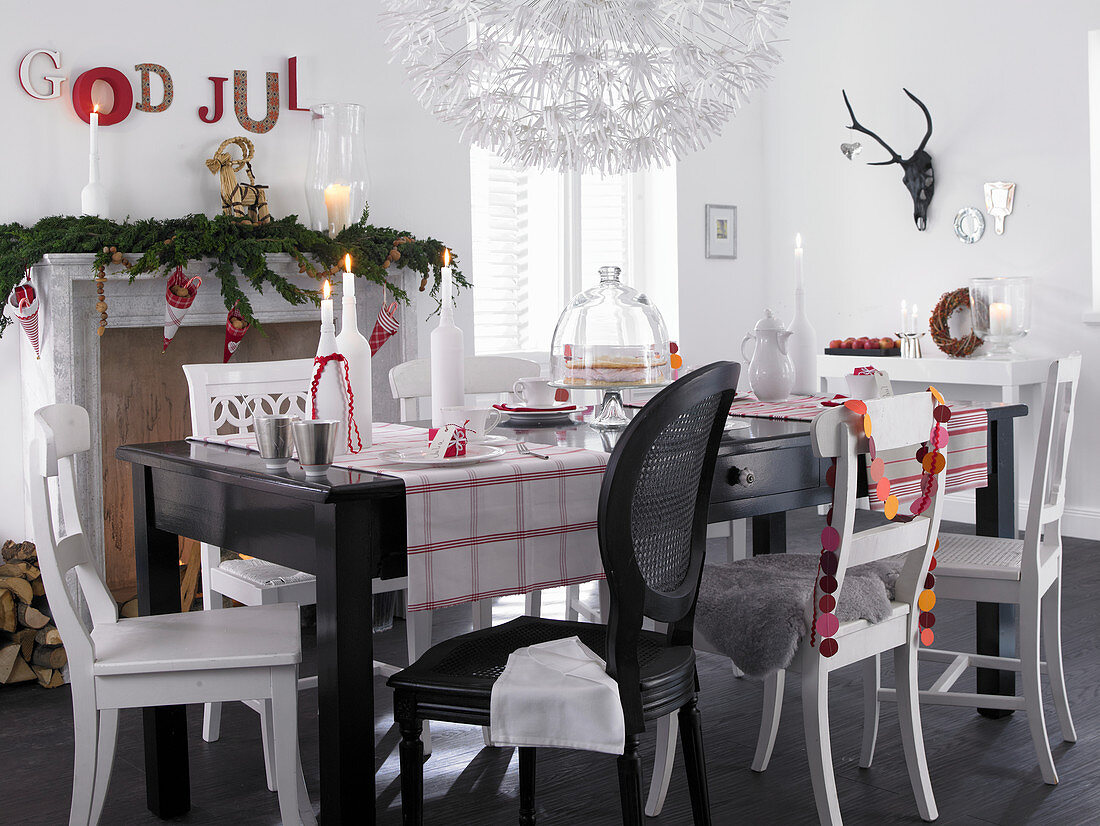 Various chairs around black table with modern Christmas decorations