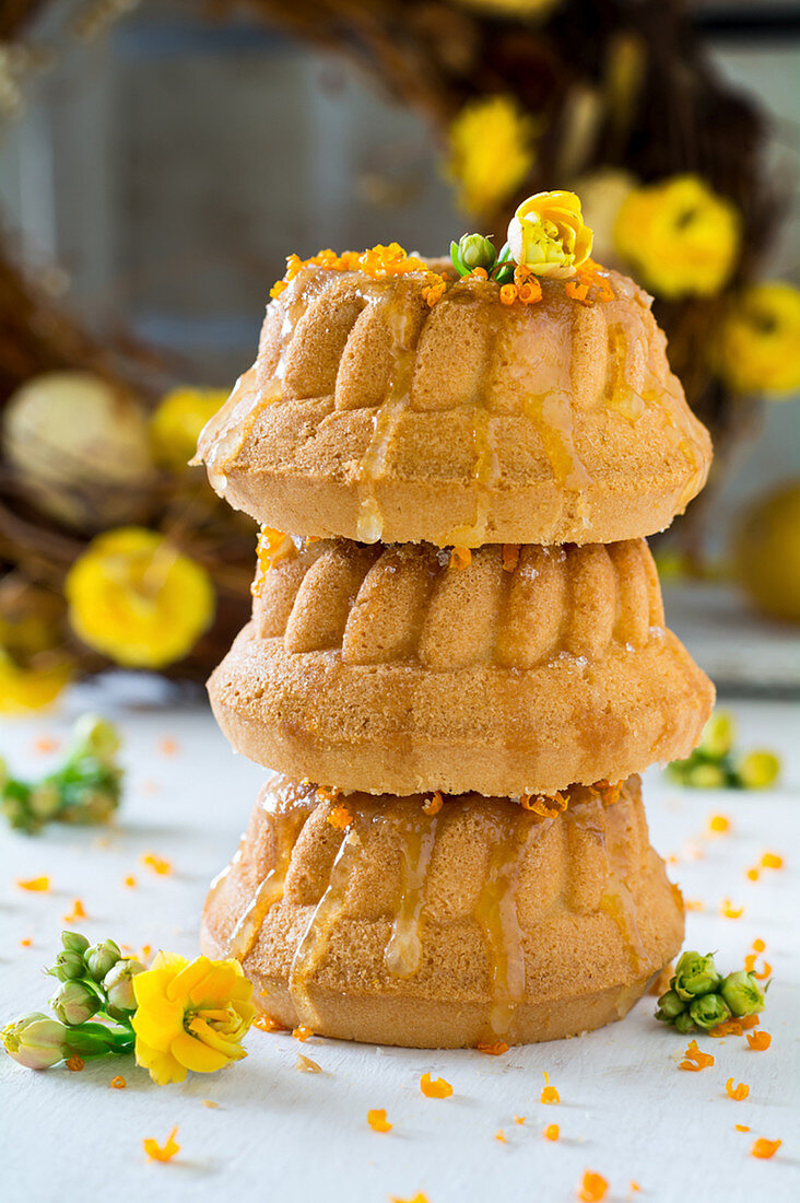 A stack of three mini Bundt cakes with honey