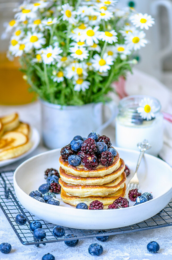 Pancakes with summer berries - blueberries and blackberries for breakfast
