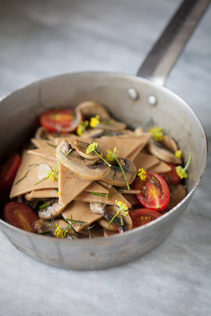 Chestnut pasta with mushrooms and tomatoes