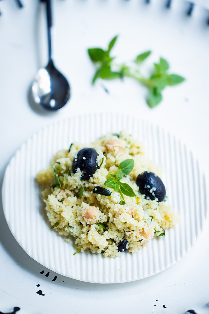 Vegan couscous salad with chickpeas, herbs and olives