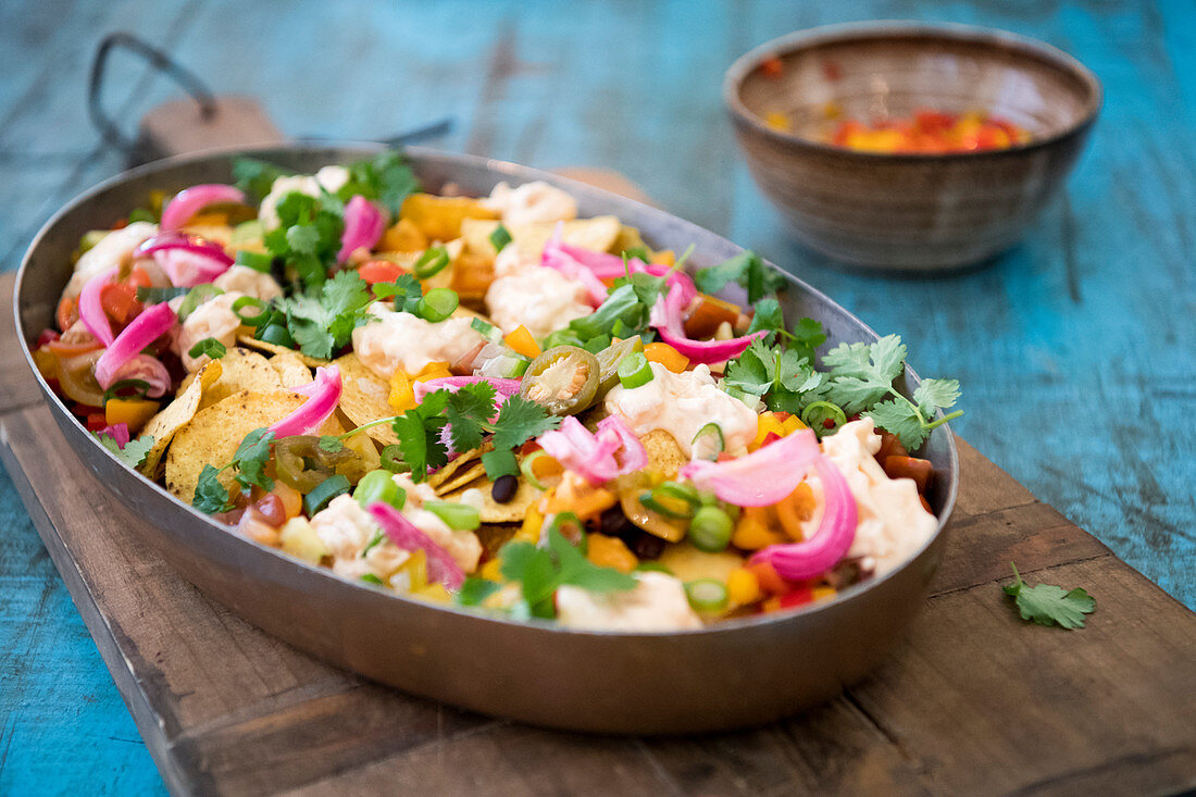 Vegeterian Nachos with vegetables cheddar kimchi and majo