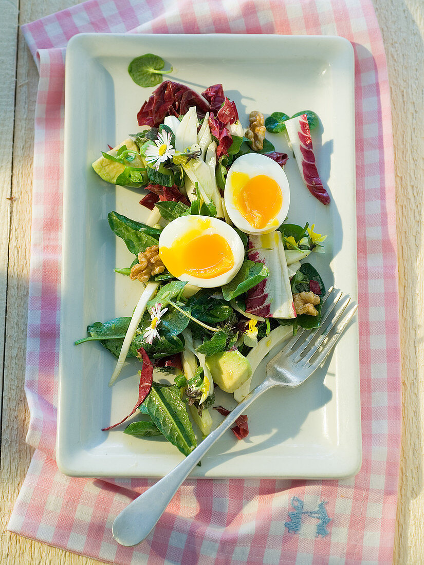 Wild herb salad with avocado and eggs for easter