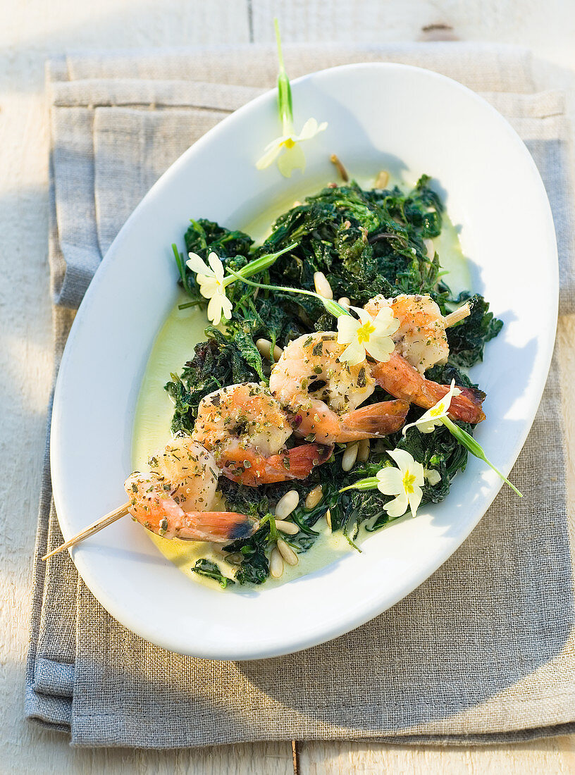 Wild herb spinach with a shrimp skewer