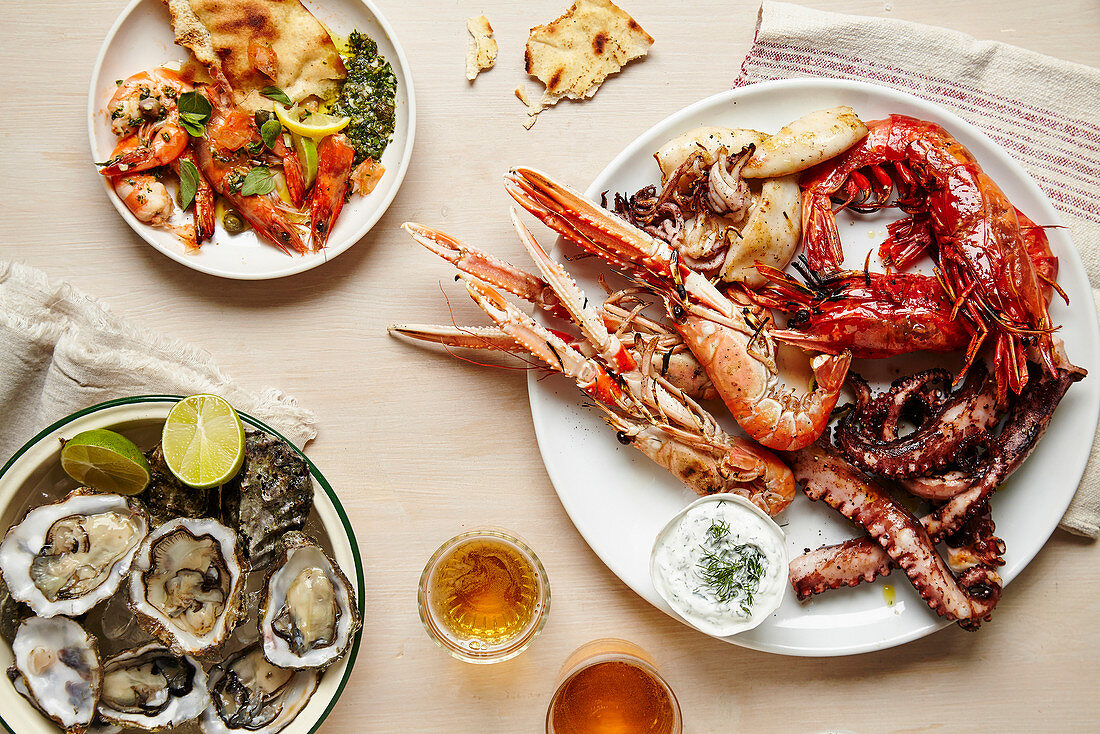 Tablescape featuring platters of fresh seafood and flatbread