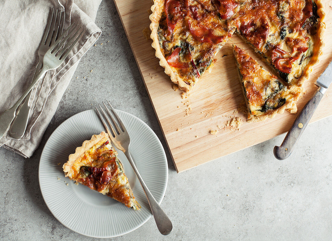 Proscuitto and Swiss Chard Tart on wooden chopping board