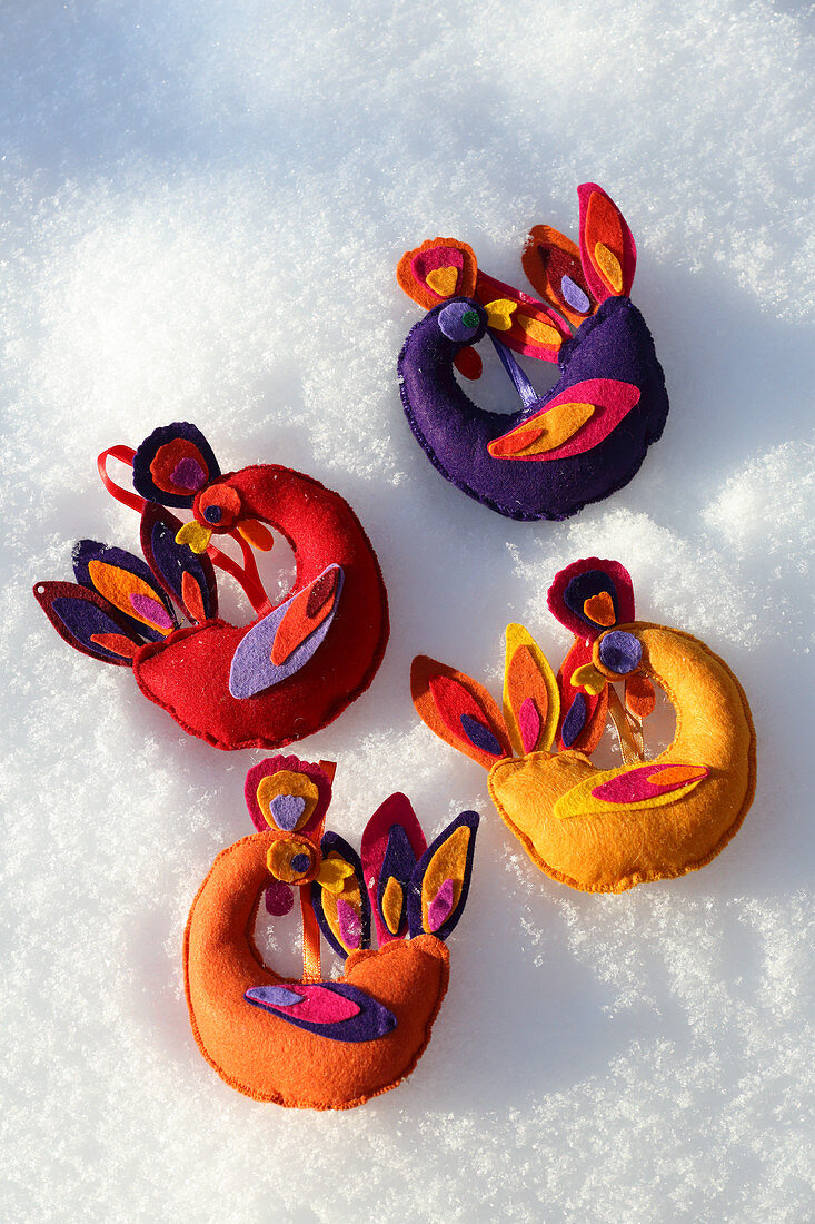 Selbstgebastelte farbenfrohe Vögel aus Filz als Christbaumanhänger