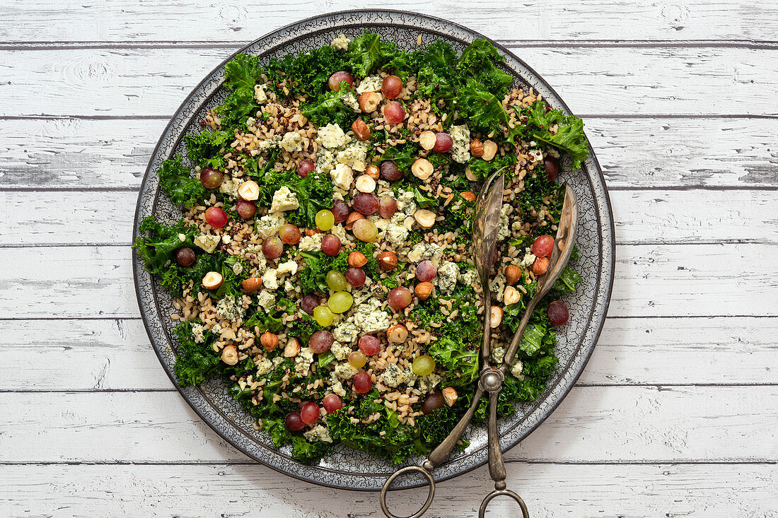 Kale salad with mixed grains, nuts and grapes