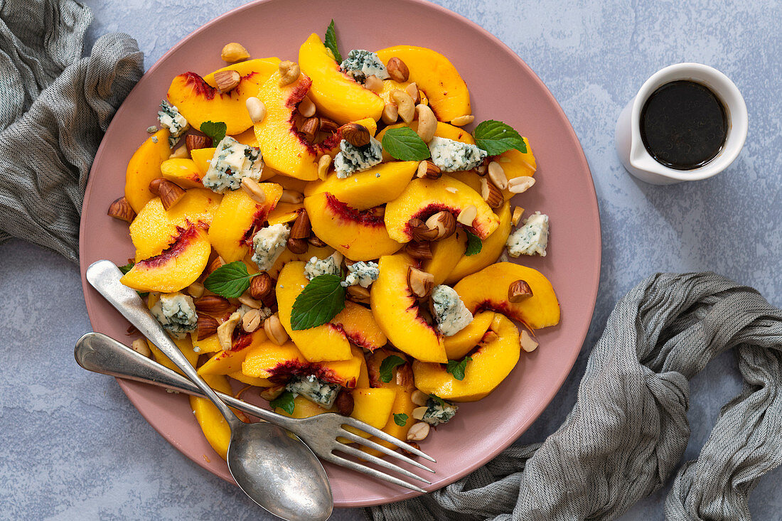 Peach salad with a fork and spoon to serve