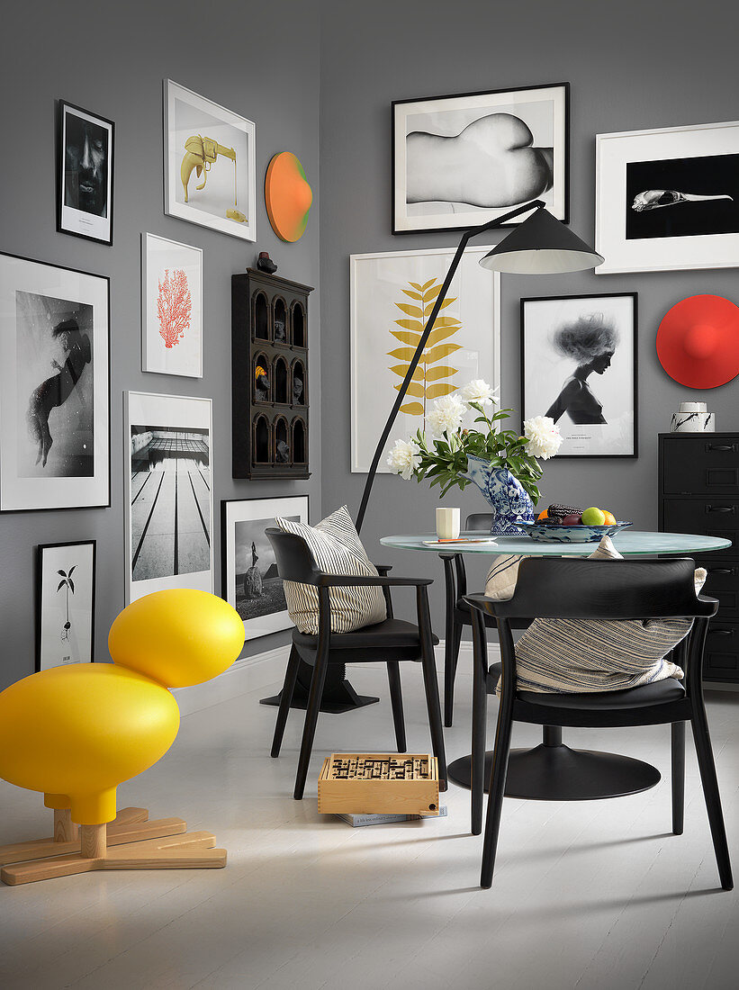 Gallery of pictures in monochrome dining room