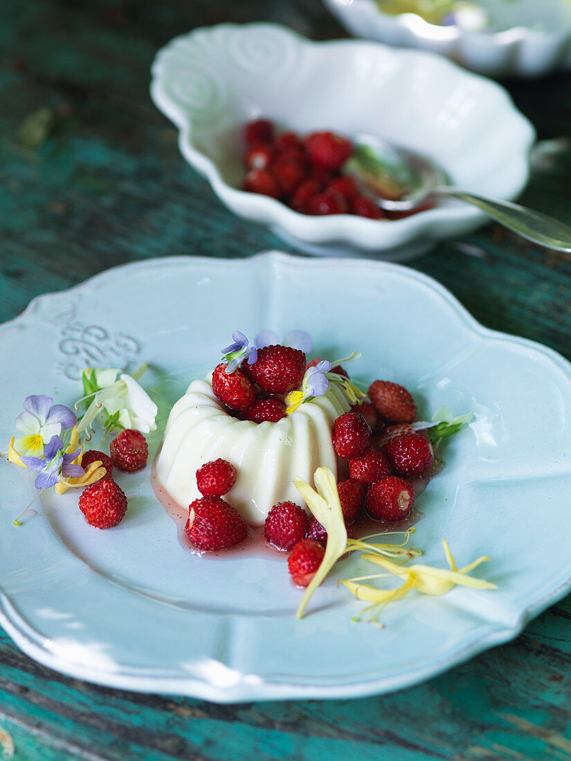 Panna cotta with wild strawberries and edible flowers