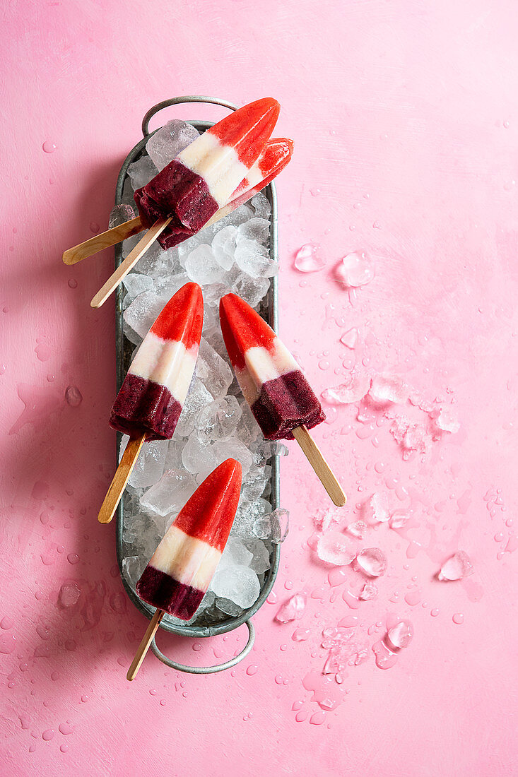 Homemade three colour (strawberry, banana and blueberry) ice lollies