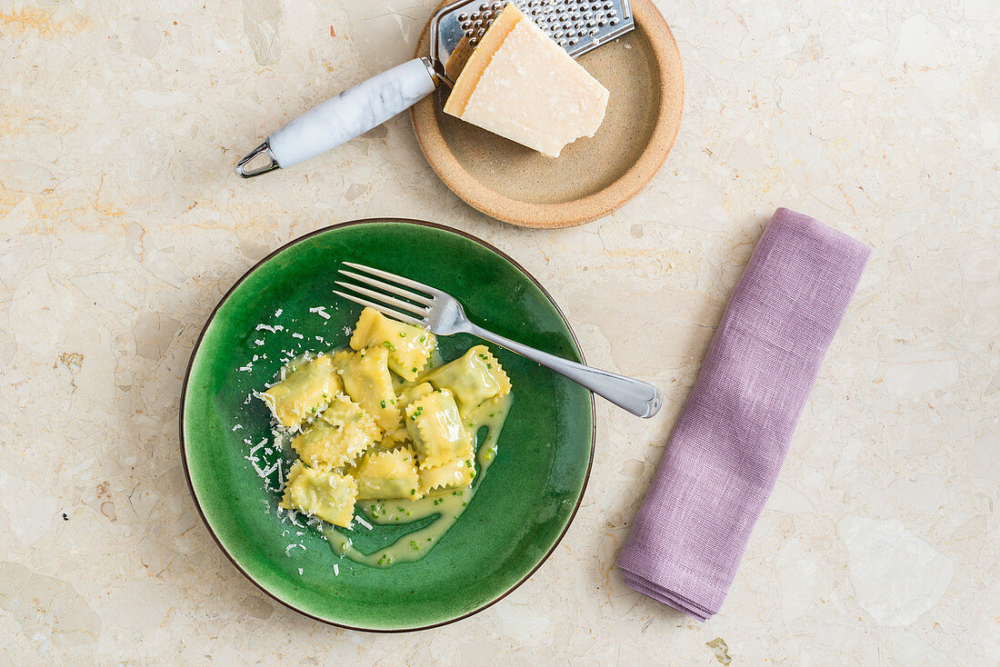 Ravioli with herb sauce and Parmesan