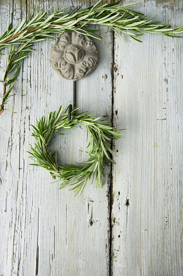 A rosemary wreath on a wooden wall