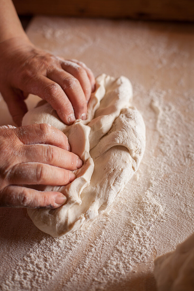 A man kneading bread dough