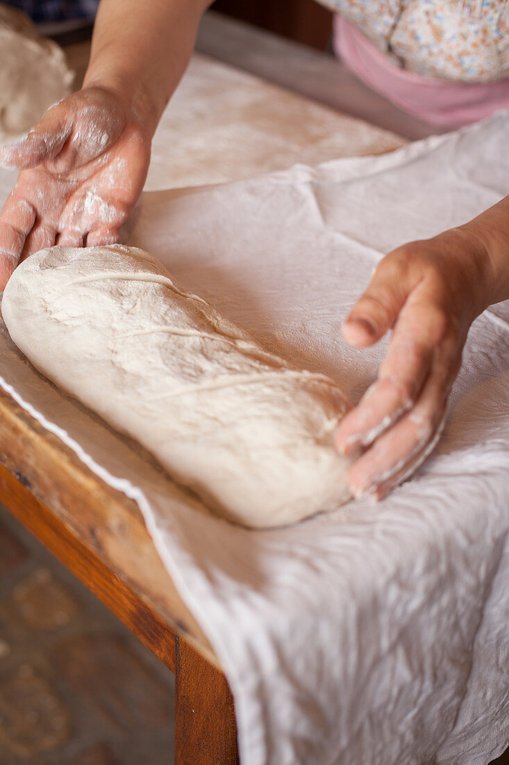 Placing bread dough on a towel