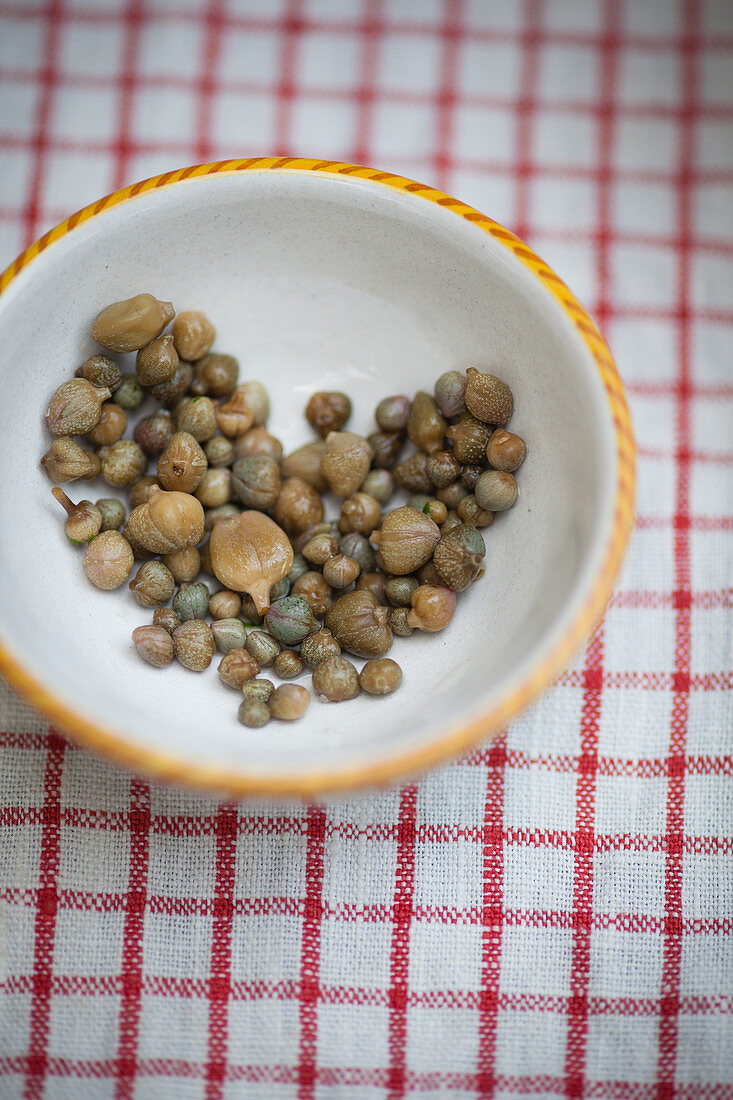 A heart of capers in a ceramic bowl