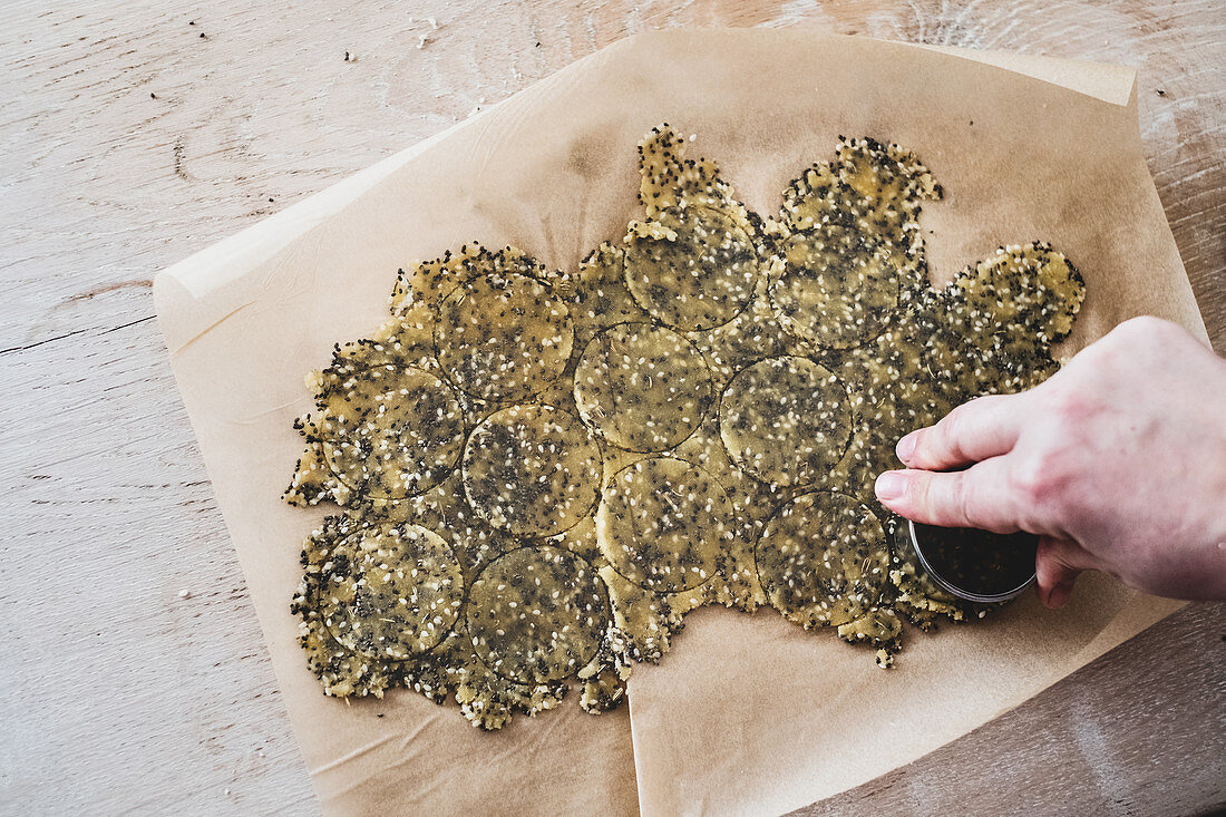 Cutting sesame cracker rounds from dough