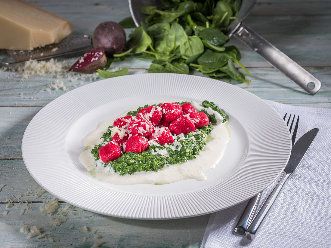 Beetroot gnocchi with creamed spinach, parmesan cheese and cream sauce