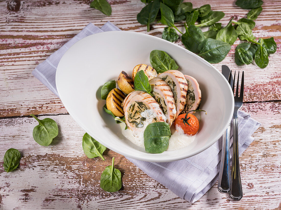 Turkey roulade with baby spinach, cherry tomato and grilled potatoes