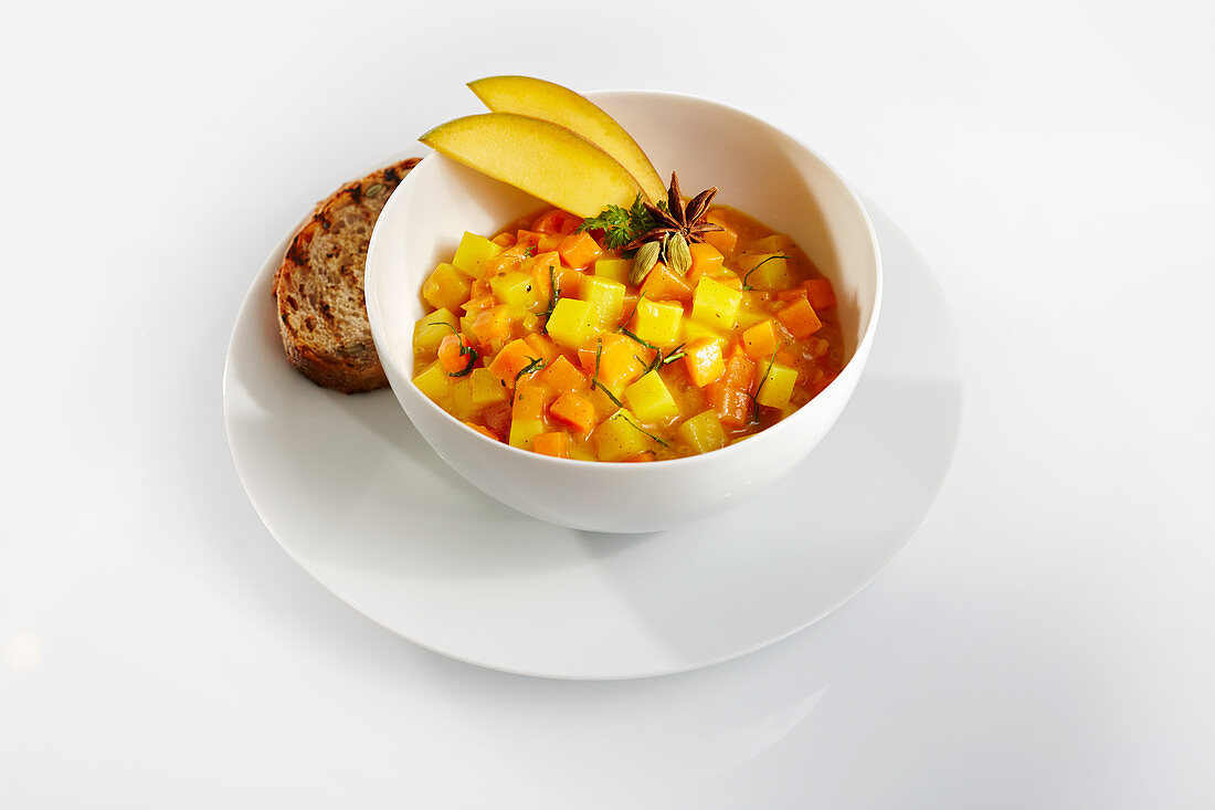 Mango, carrot and pumpkin stew with toast and star anise