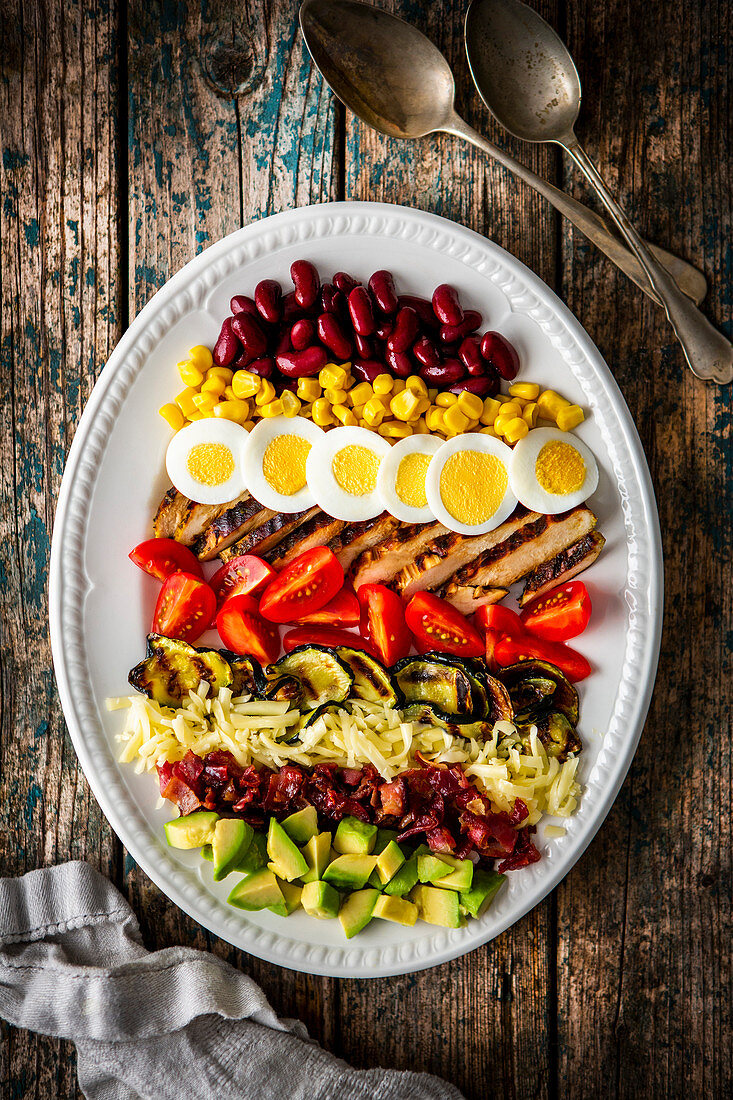 Cobb salad with vegetables, cheese, beef, corn and egg (USA)