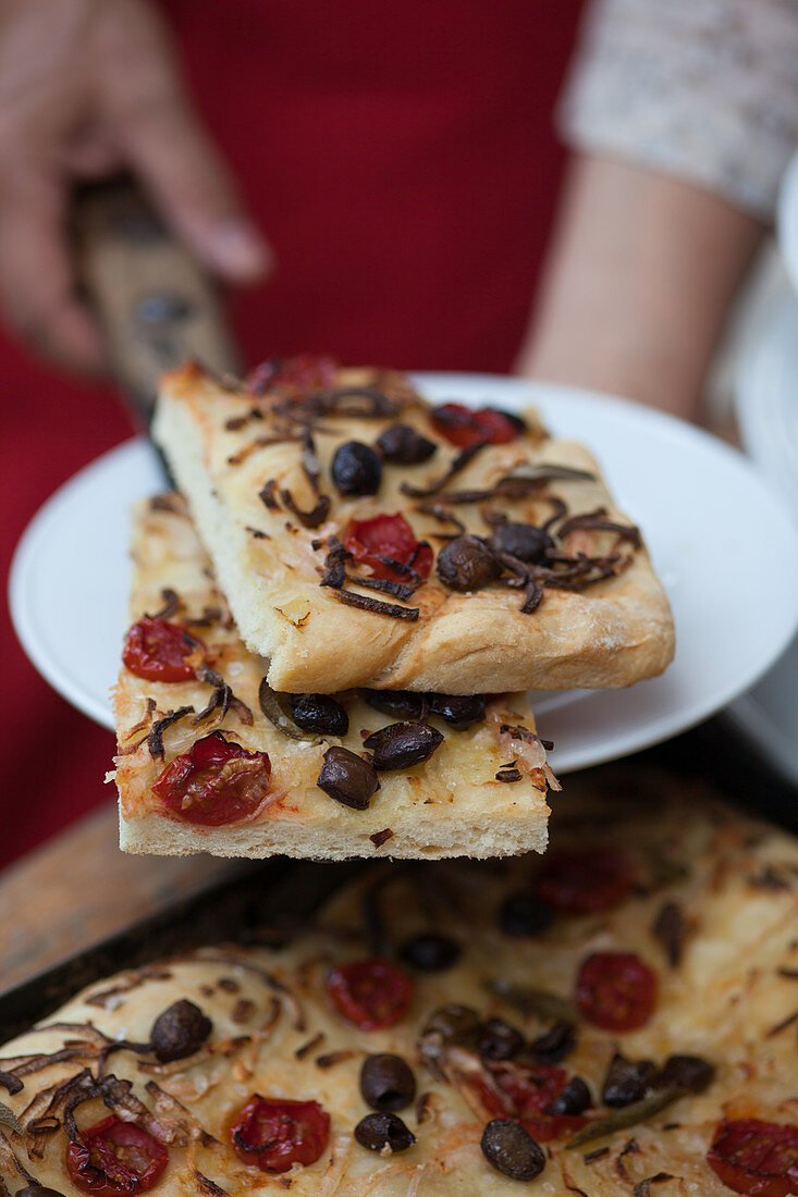 Freshly baked focaccia with tomatoes and olives