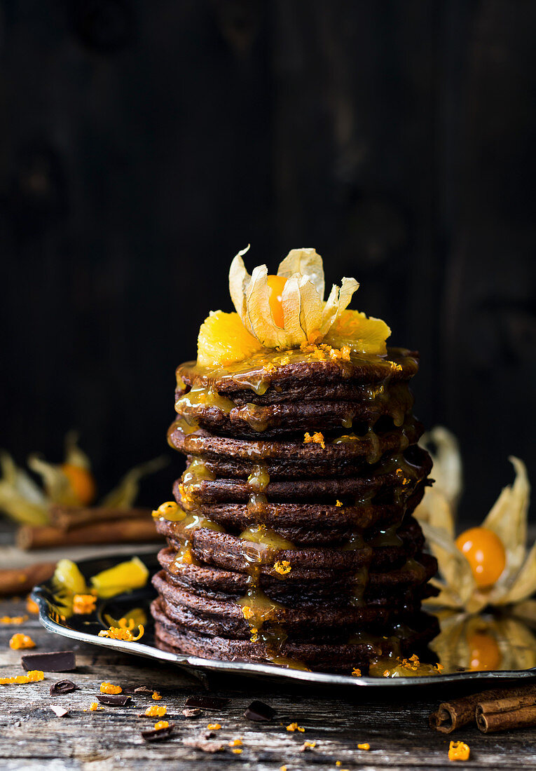 Chocolate pancakes with oranges and physalis