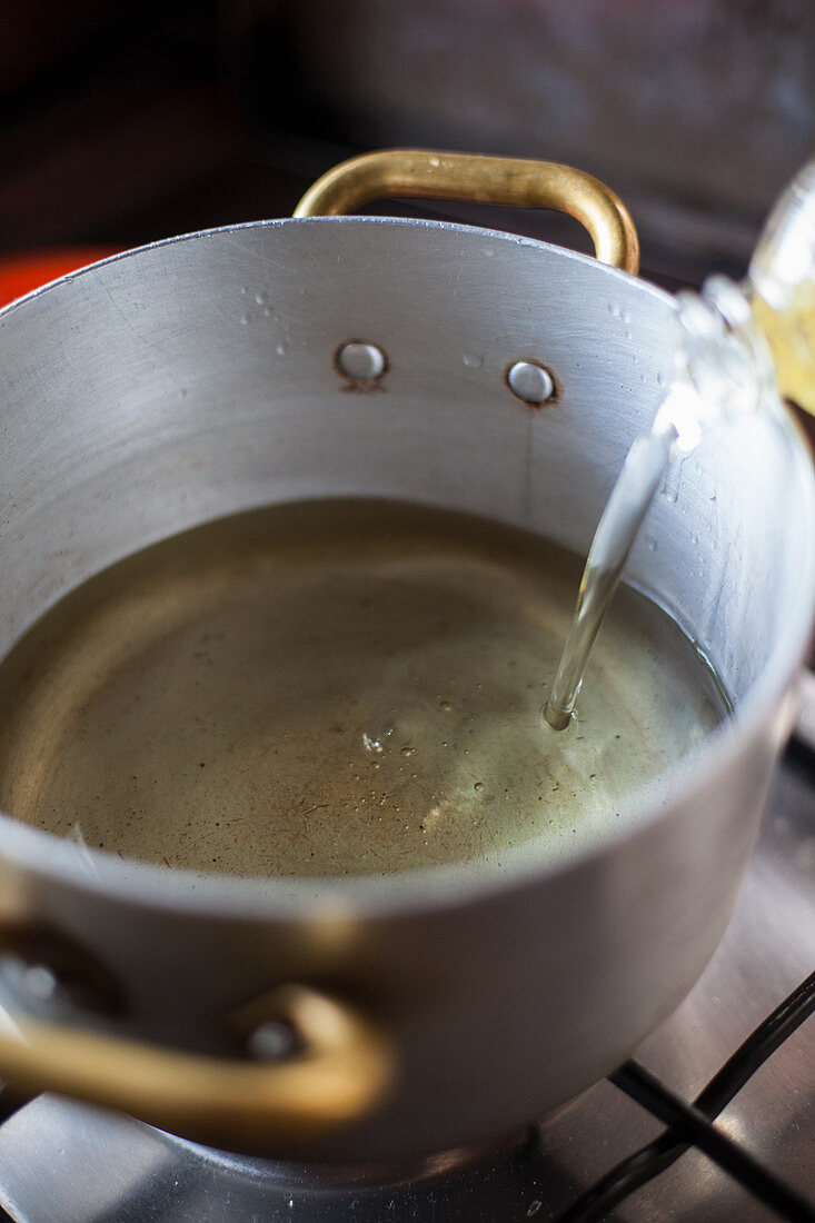Pouring oil into a saucepan