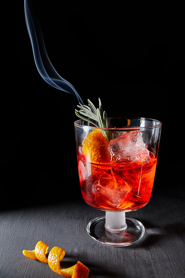 Negroni with a smoldering rosemary sprig