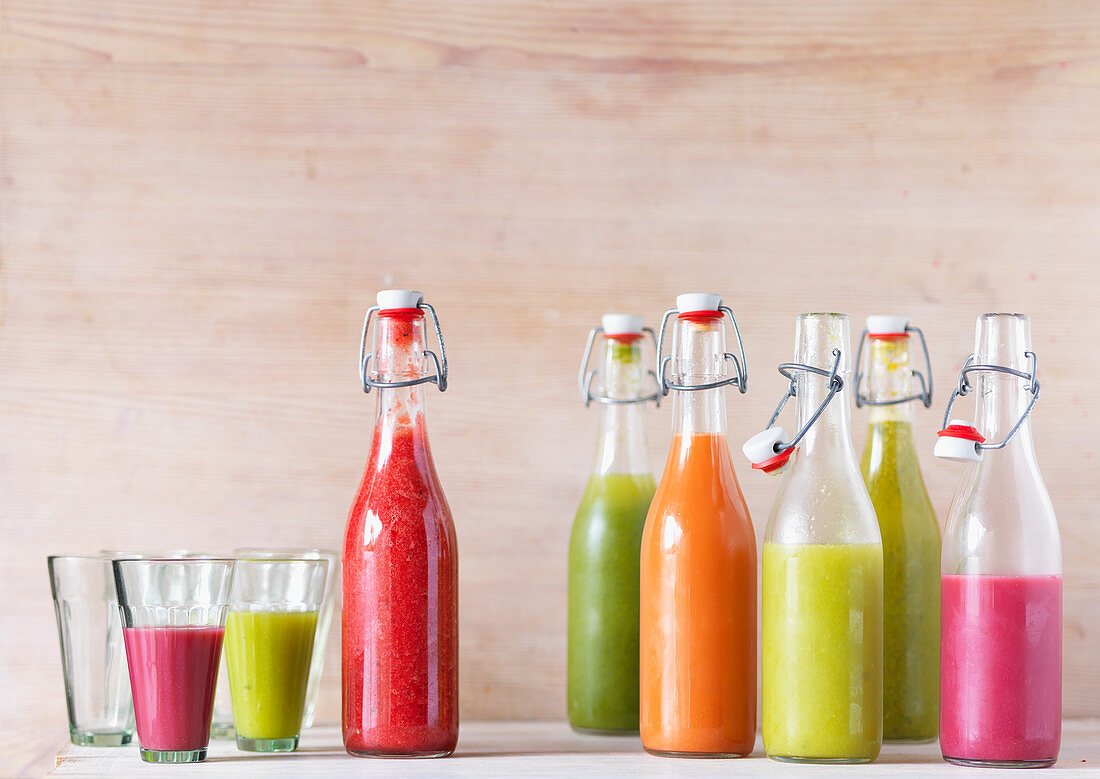 Various smoothies in bottles and glasses