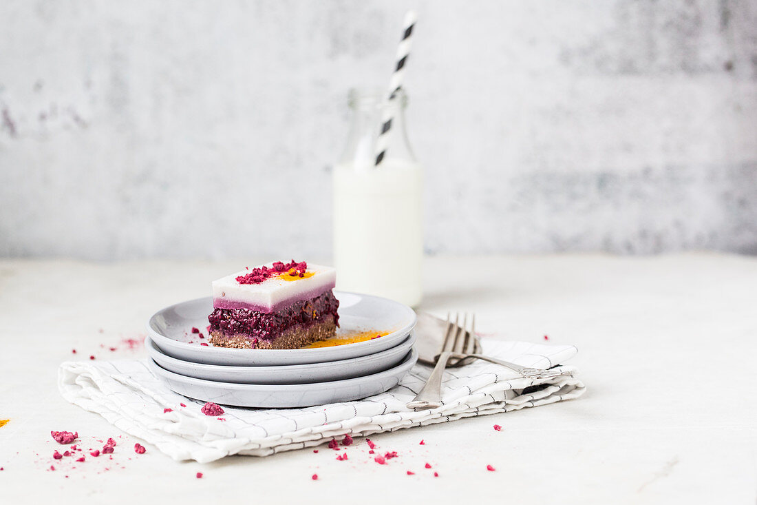 A slice of raspberry panna cotta cake with turmeric