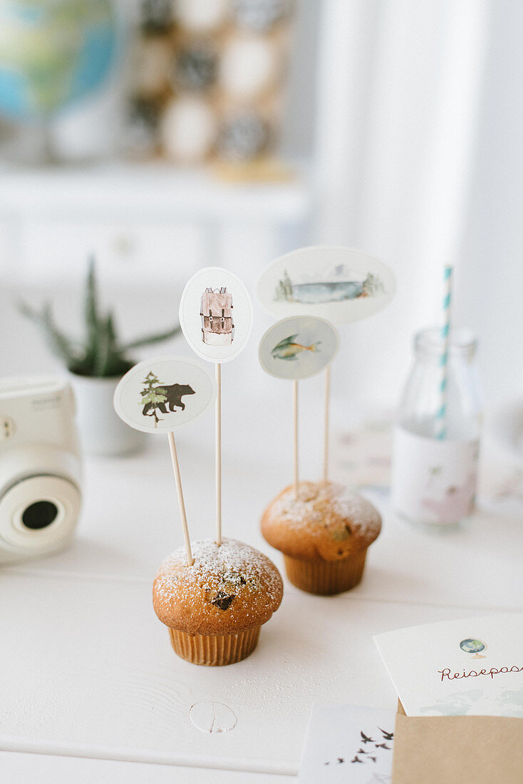 Muffins decorated with handmade decorative skewers for child's birthday party