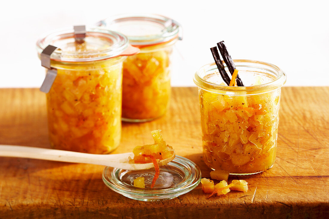 Preserved quince chutney with oranges, vanilla and Malabar pepper in mason jars