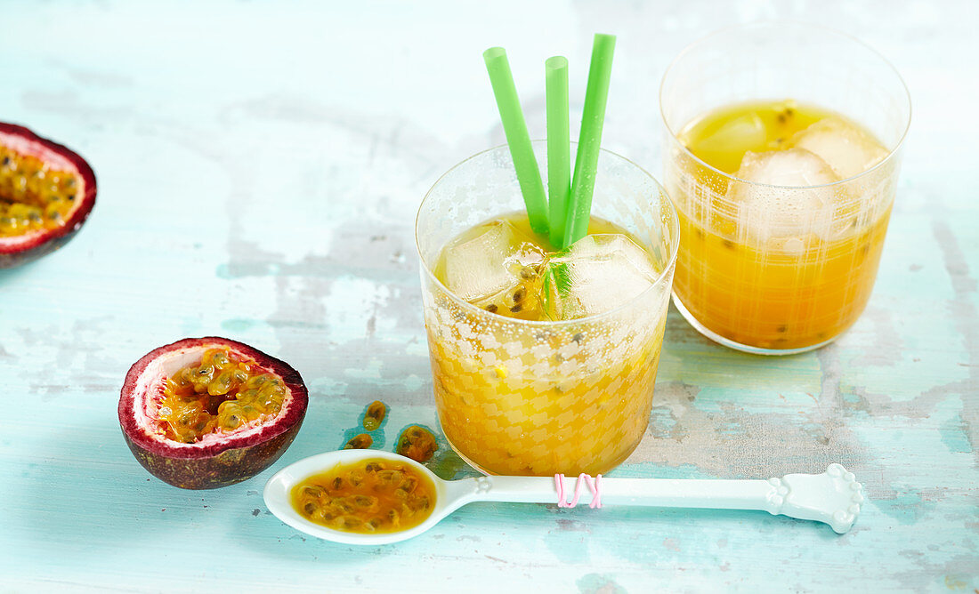 Encanto Tropical - cocktails with passion fruit, almond liqueur, ice and straws