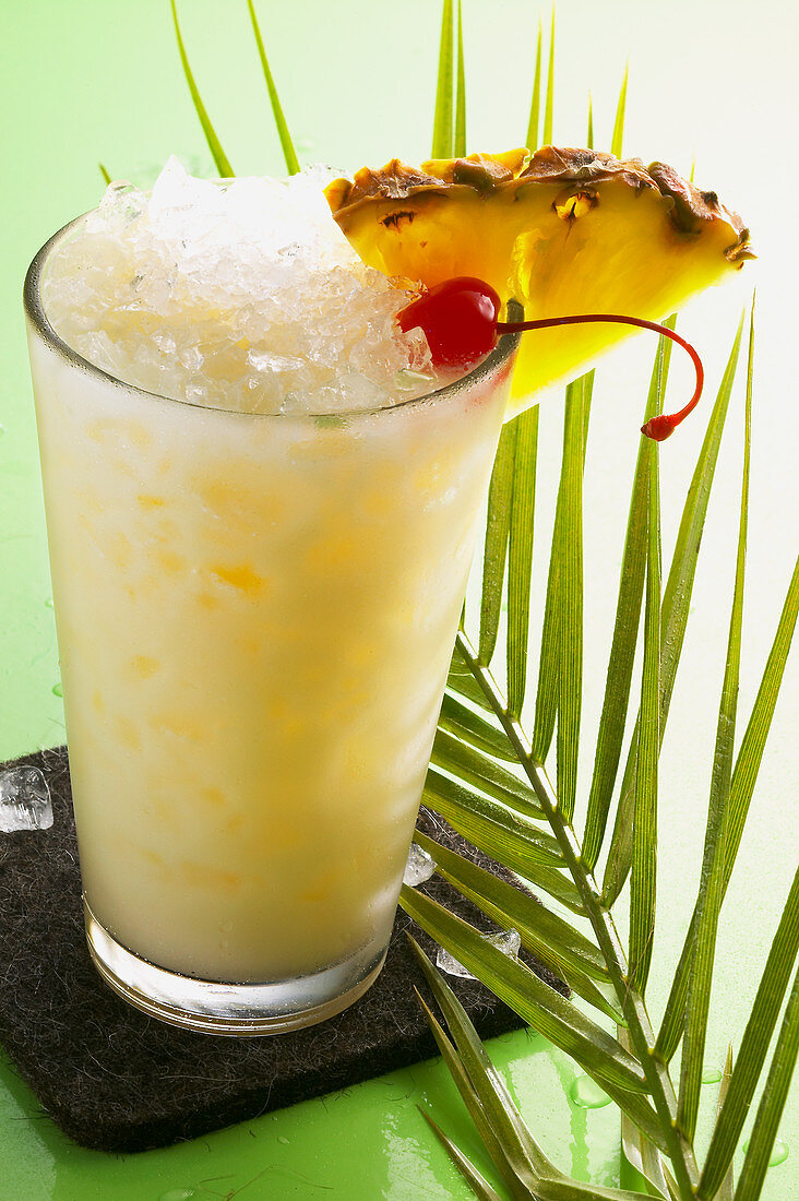 A Pina Colada garnished with a cocktail cherry