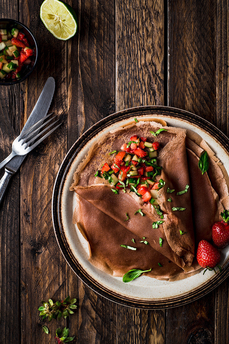 Cocoa pancakes with strawberry, basil and cucumber salad