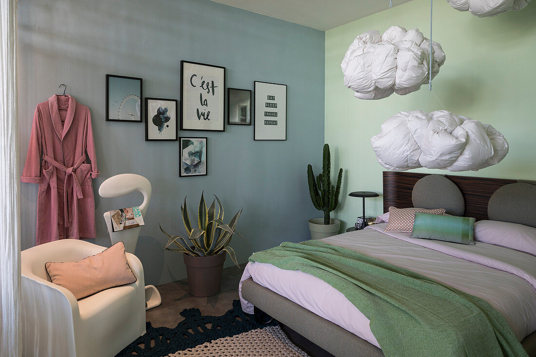 Walls of different colours and cloud-shaped pillows hung from ceiling in bedroom