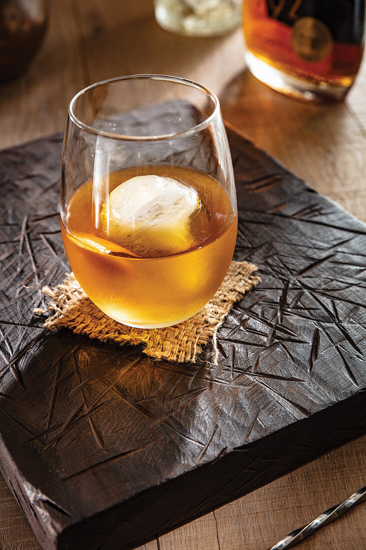 Vermouth and bourbon coacktail with ice cube