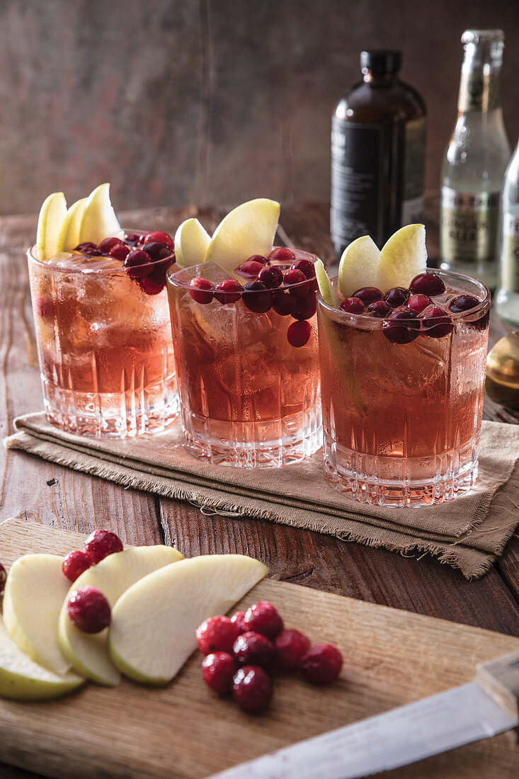Three apple cranberry mule cocktails