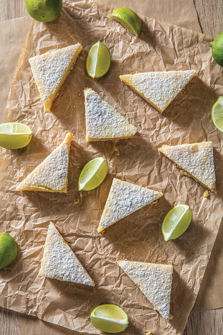 Key lime bars triangles with lime slices on butcher paper