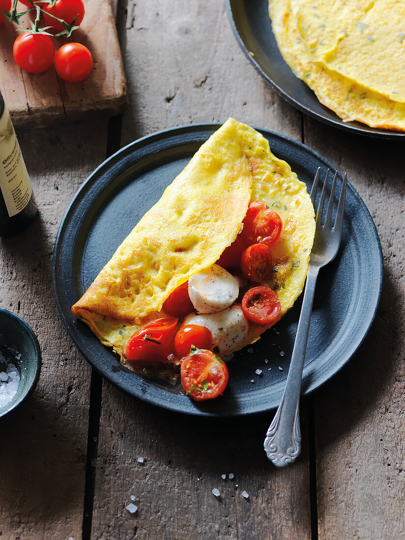 Stuffed sweetcorn crepes with tomatoes