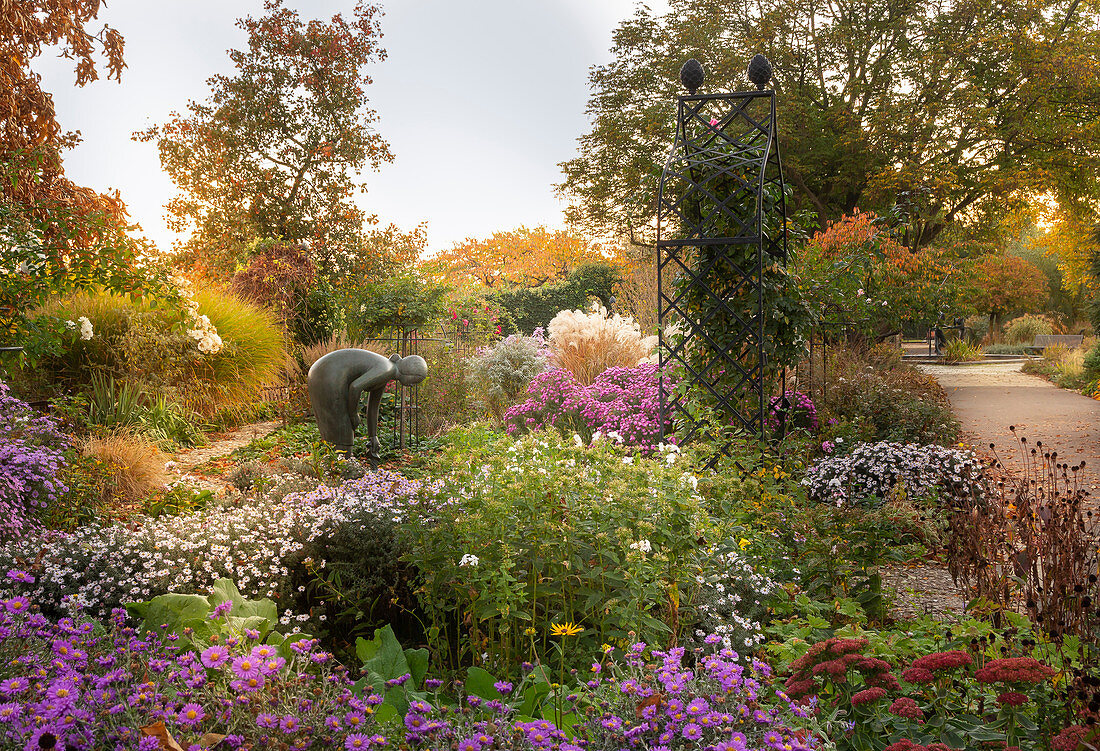 Bronze sculpture in flowering garden (district teaching garden, Steinfurt, Germany)