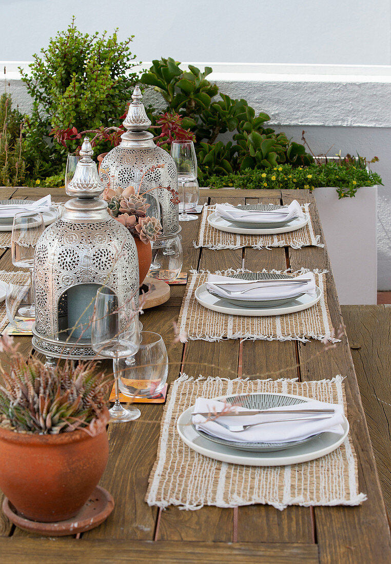 A table laid for a meal on raised decking