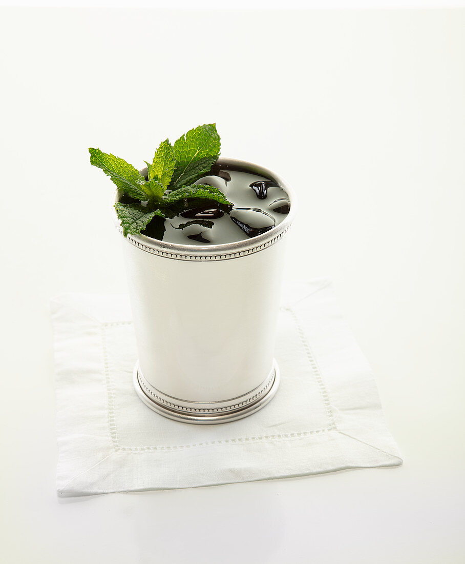 Mint julip in silver cup garnished with mint leaves