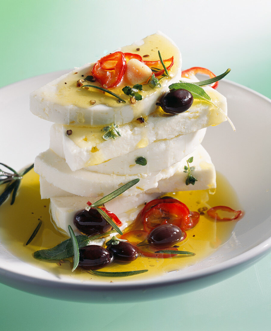 Marinated feta cheese with olive oil, chilli peppers, olives and rosemary