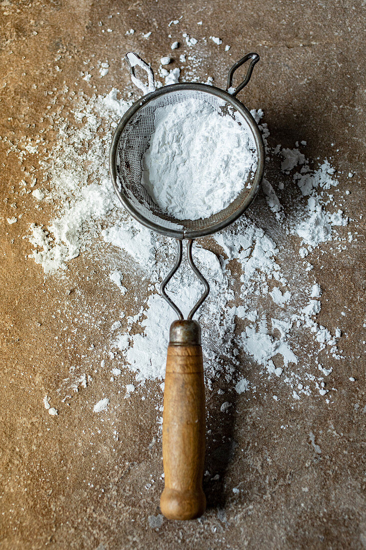 Icing sugar in an old sieve