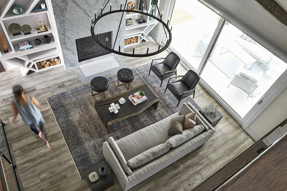 Traditional living room with marble fireplace, shelves, wooden floor and sliding glass doors